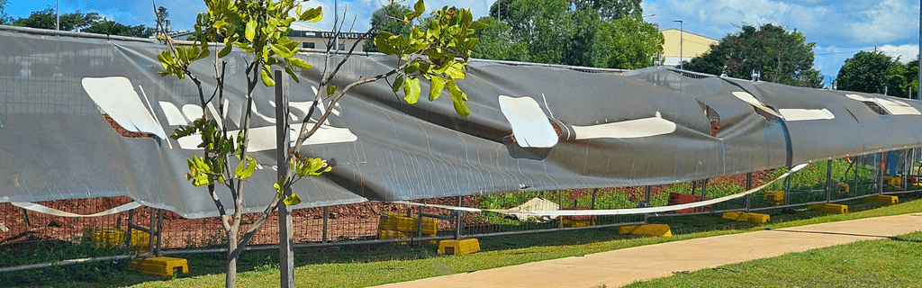 Messy banner Mesh on a temporary fence damages brand perception and credibility 